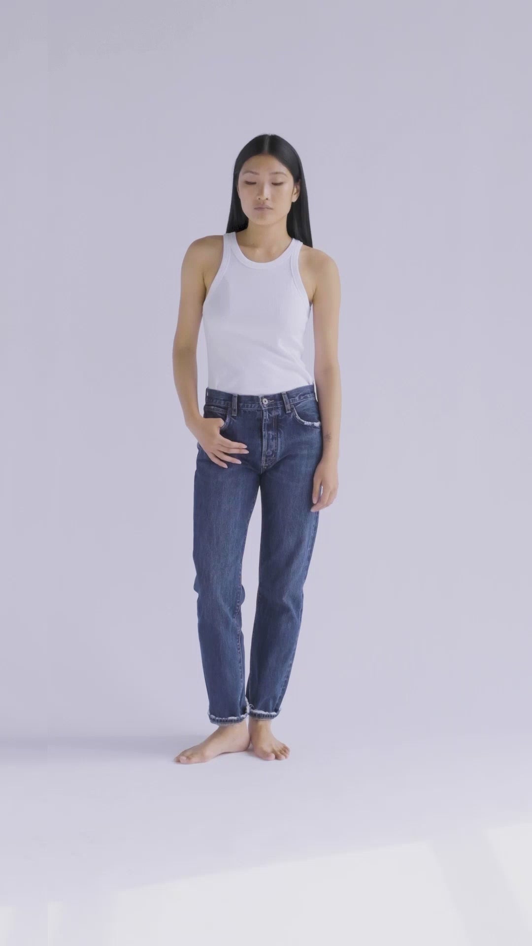 10-second video of a fit model presenting the B O R O デニム (BORO DENIM) 'Tokyo Eagle bird' jeans. The model makes a full 360-degree turn, highlighting the jeans' slim silhouette, tapered waist, and unique vintage charm. The roll-up style is demonstrated for a playful, casual flair.