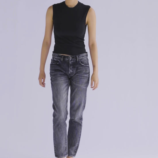10-second video of a fit model presenting the B O R O デニム (BORO DENIM) 'Sapporo All Eyes on Me' jeans. The model makes a full 360-degree turn, highlighting the jeans' slim silhouette, tapered waist, and unique vintage charm. The roll-up style is demonstrated for a playful, casual flair.